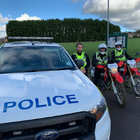 Three special constables next to a police car