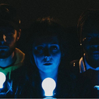 Three characters holding lightbulbs to their face