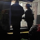 Two police officers stood outside a police van