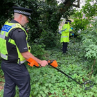 Two police officers searching for weapons in a bush