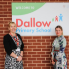 Two women stood next to Dallow Primary School sign