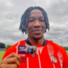 Gabe Osho holding a Safe to Play card