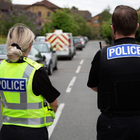 Two officers stood facing away from camera