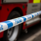 Police tape in front of fire engine