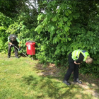 Two officers carrying out a weapons sweep in a bush