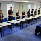 Student officers lined up reading off sheets of paper