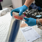 Man putting a knife in a forensic evidence tube