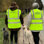 Two volunteers stood with their dogs