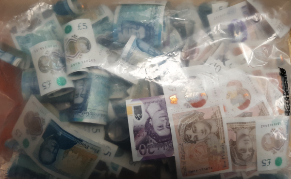 large amount of cash in a plastic wallet