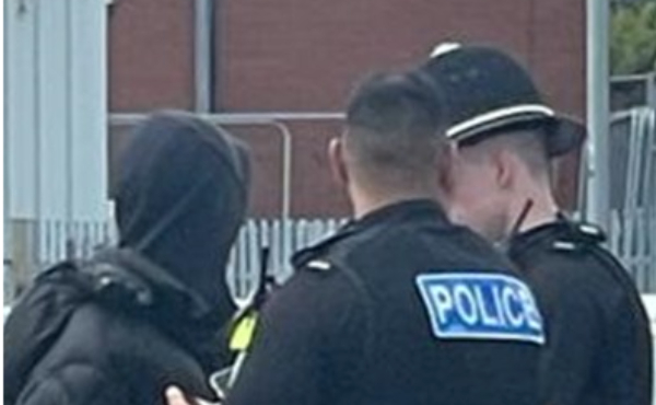 Person being arrested by two police officers