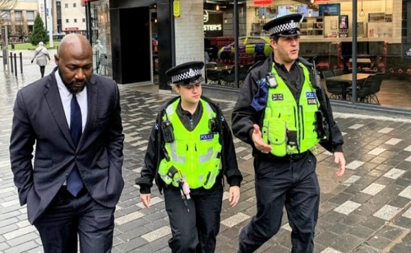Police and Crime Commissioner Festus Akinbusoye walking with police officers