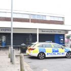 Police car and police tape at a scene