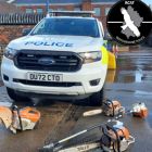 Police car with tools on floor.