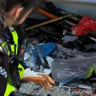 Female police officer emptying weapon bin