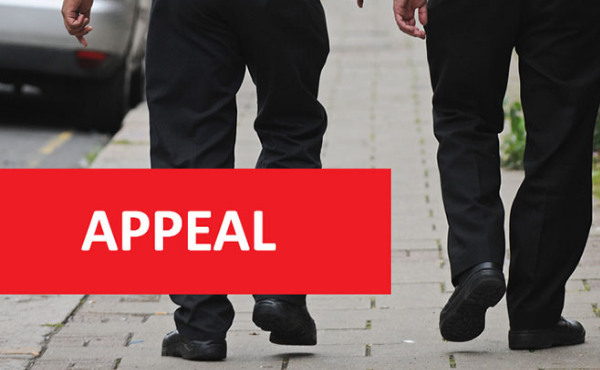 The backs of the legs of officers walking