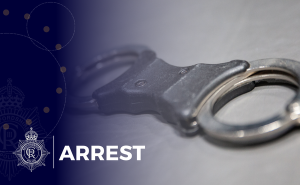 A set of handcuffs with the words arrest over the top
