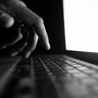 Hand typing on laptop