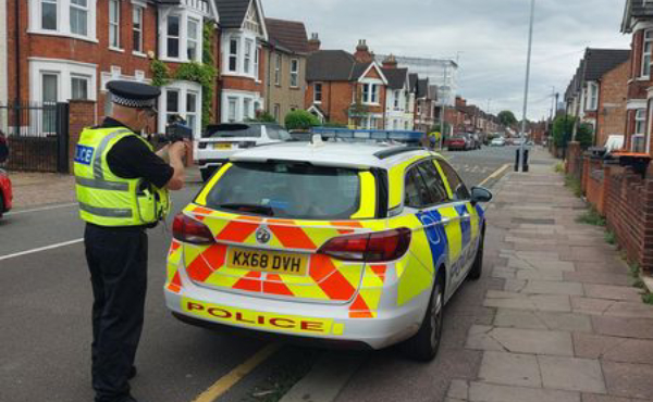 Patrol car and officer with speed gun