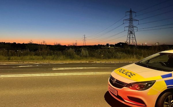 Car at night with sunset in the background
